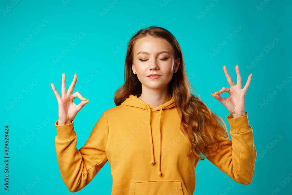 Young woman meditating with her hands in yoga gesture Young woman meditating with her hands in yoga gesture