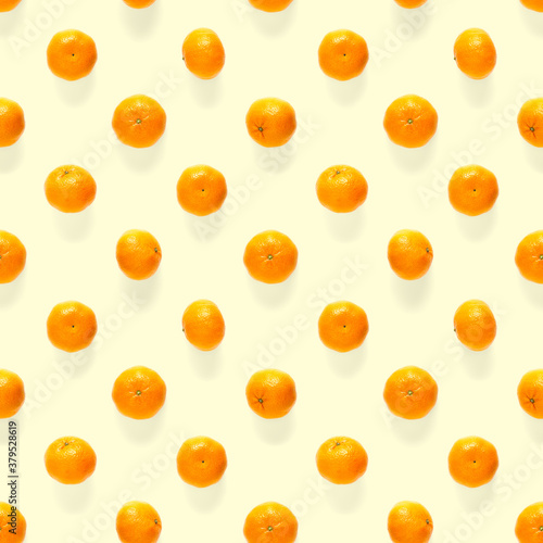 Fresh mandarine Seamles pattern. Ripe fruit tangerines seamless pattern. Fresh citrus isolated on yellow background pattern. Flat lay of Clementine.