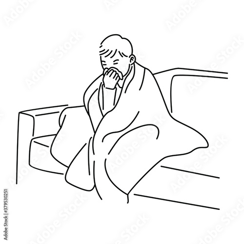 Sick boy sitting in sofa with a tissue in mouth and feel so bad with fever