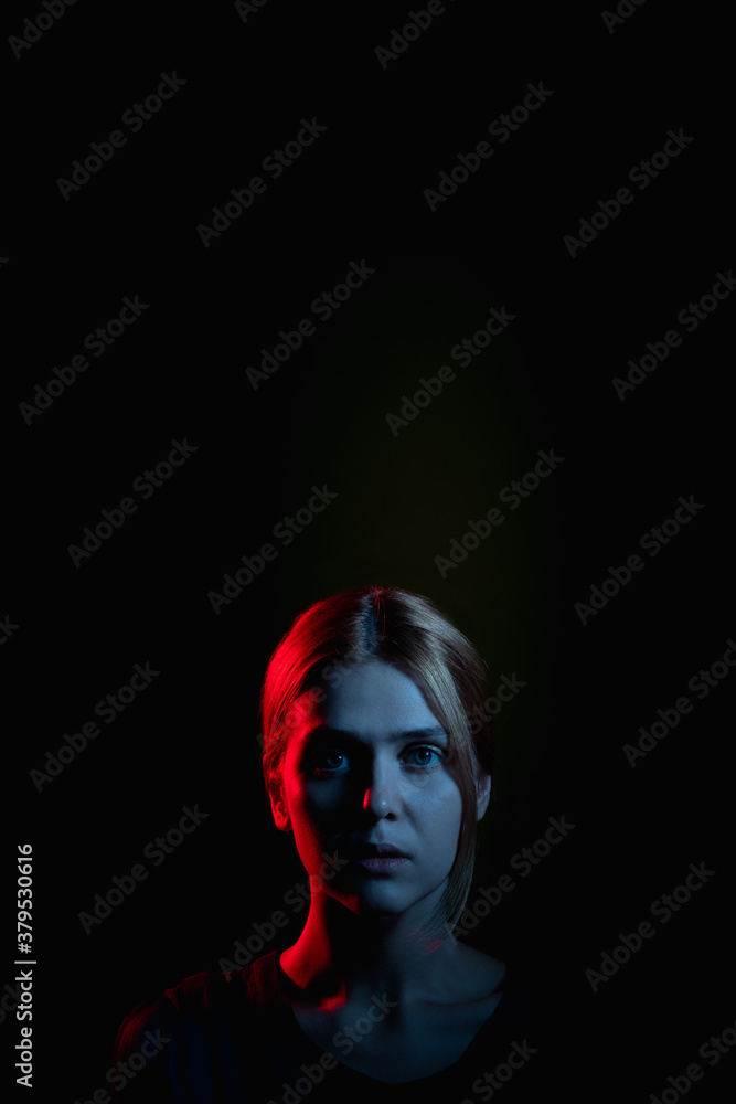 Female silhouette portrait. Stuck problem. Frustrated woman in neon light glow looking at camera isolated on black. Psychology support. Domestic violence. Feeling helpless. Toxic relationship Female silhouette portrait. Stuck problem. Frustrated woman in neon light glow looking at camera isolated on black. Psychology support. Domestic violence. Feeling helpless. Toxic relationship
