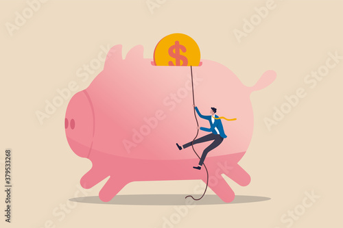 Personal finance strategy, income tax or investment target for office worker retirement concept, confidence businessman using rope to climb up pink piggy bank with golden money coin as final target.