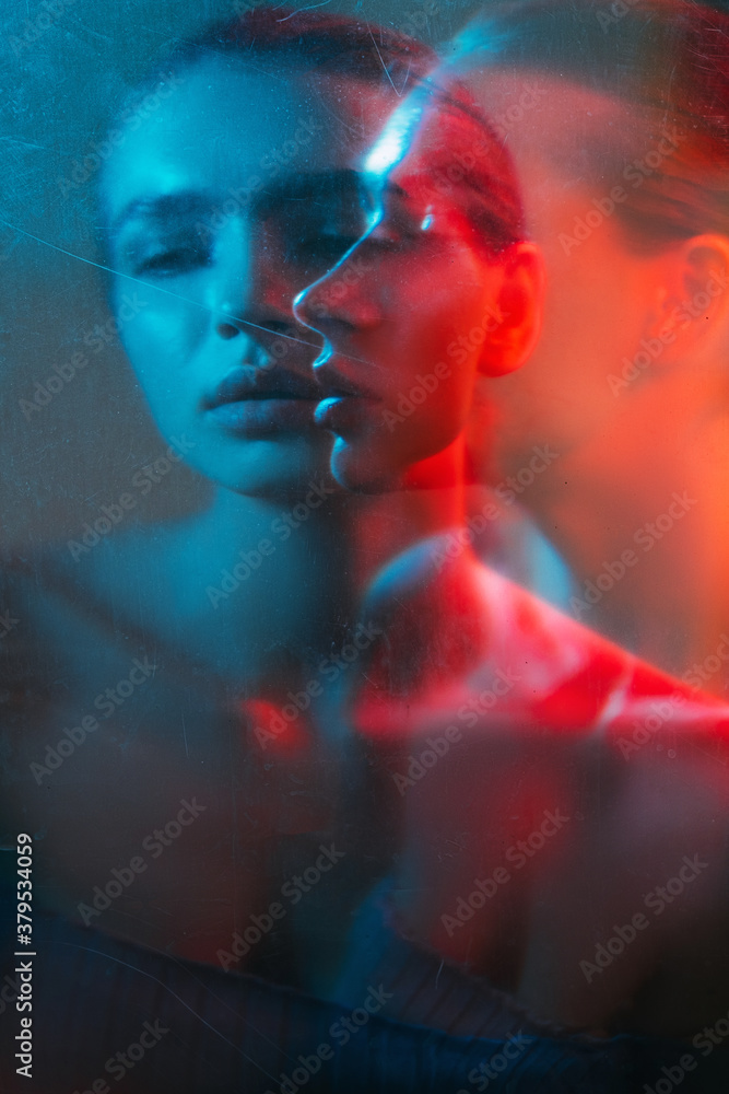 Bipolar disorder. Mental health. Depressed woman blur silhouette in red blue bokeh light with old film dust scratches stains double exposure. Fear crisis. Psychotherapy practice. Stress anxiety.