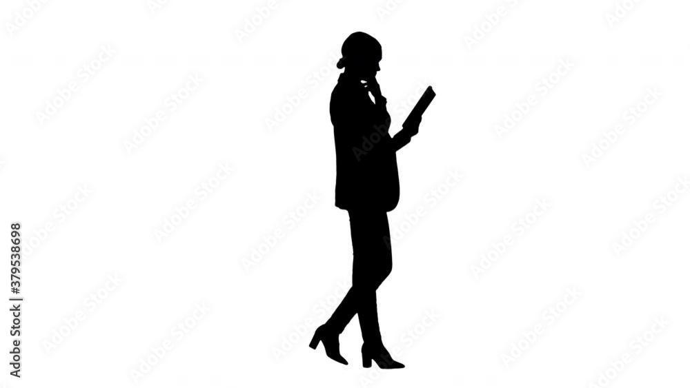 Silhouette Businesswoman using a tablet pad while walking. Silhouette Businesswoman using a tablet pad while walking.