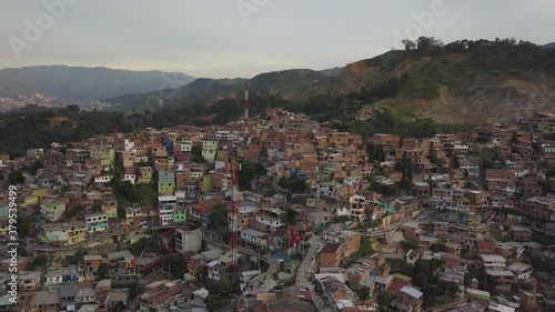 Medellin, Colombia. Aerial View of Colorful Hillside Buildings in Comuna 13 Slum at Evening, Parallax Drone Shot photo