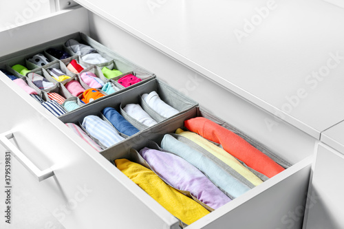 Canvas Print Open drawer with clean clothes in closet