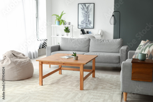 Armrest table on sofa in interior of room