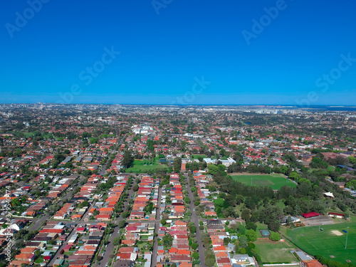 Panoramic Aerial Drone view of Suburban Sydney housing, roof tops, the streets and the parks © Elias Bitar