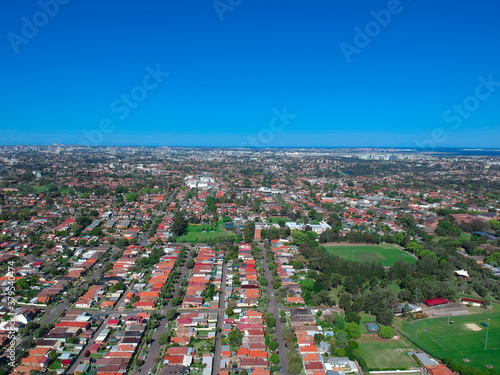 Panoramic Aerial Drone view of Suburban Sydney housing, roof tops, the streets and the parks