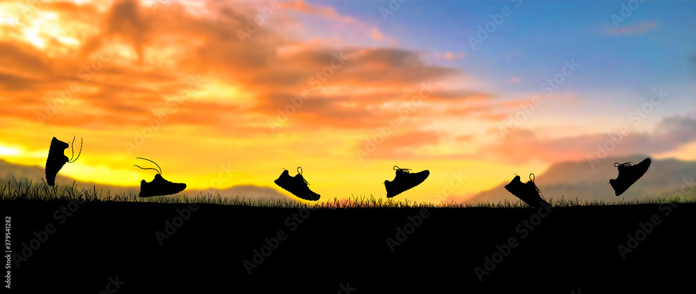Obraz premium Concept design for Trail running : Silluette running Shoe running along the way at the sunset time.