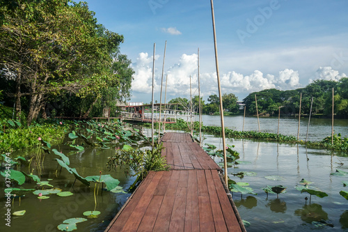 Nakornpathom / Thailand - September 5 2020: wooden walkway at floating raft along the river at Tree & Tide cafe photo