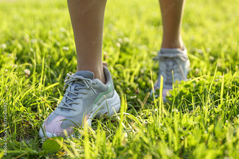 woman's legs wearing sporty sneakers outdoor close up woman's legs wearing sporty sneakers outdoor close up