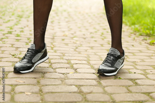 woman's legs wearing sporty sneakers outdoor close up