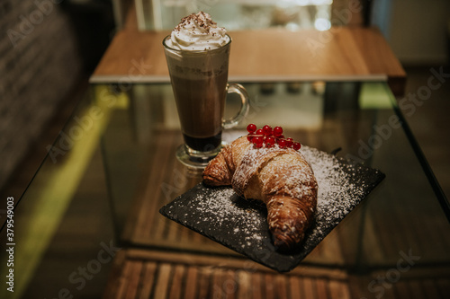 croissant with cream and cappuccino