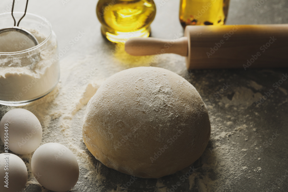 Concept for baking with dough on gray background Concept for baking with dough on gray background