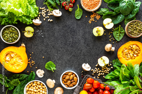 Healthy food background. Autumn fresh vegetables on dark stone background with copy space, top view