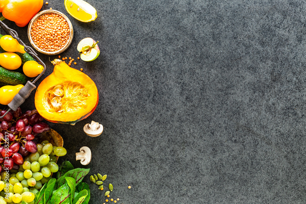 Healthy food background. Autumn fresh vegetables on dark stone background with copy space, top view Healthy food background. Autumn fresh vegetables on dark stone background with copy space, top view