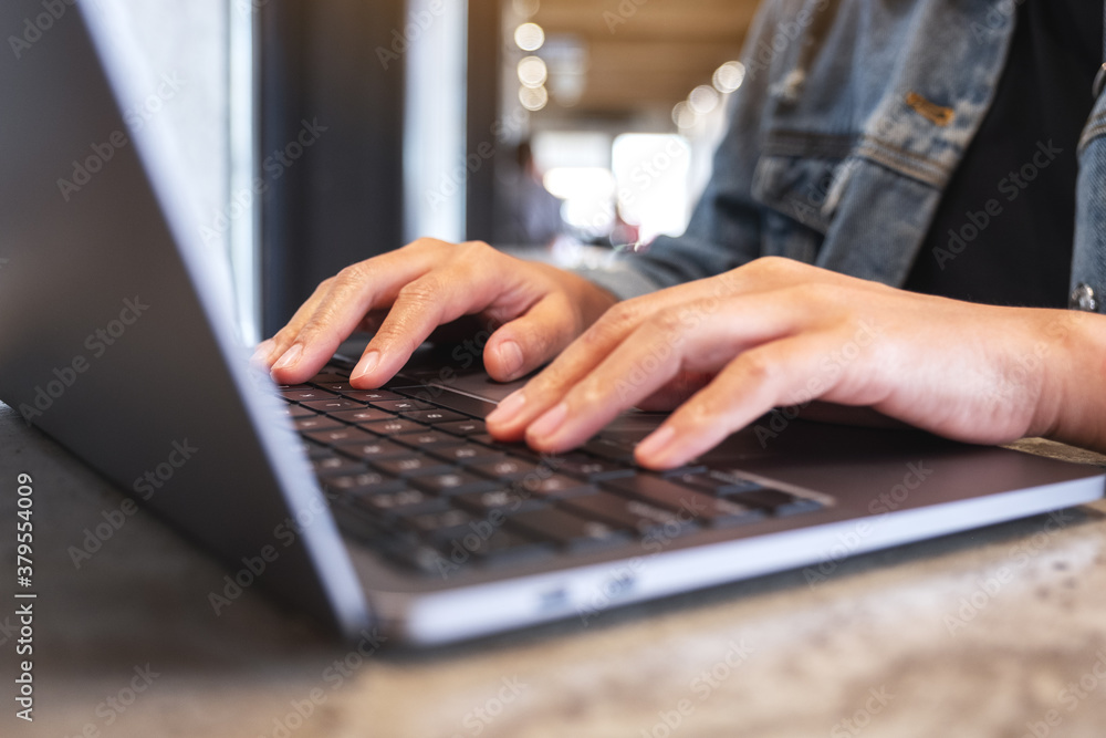 Closeup image of hands working and typing on laptop computer keyboard on the table Closeup image of hands working and typing on laptop computer keyboard on the table