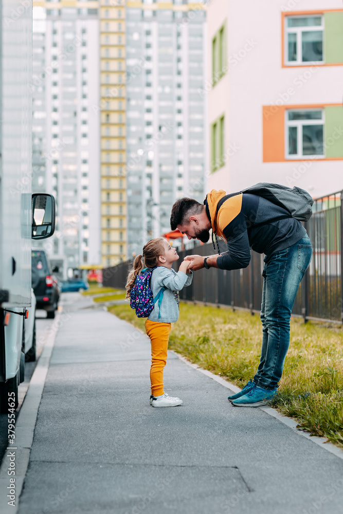 Father and daughter going to school for the first time. Back to school after pandemic.