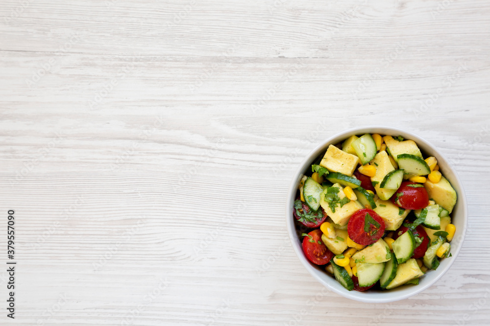 Fresh Avocado Tomato Salad in a bowl on a white wooden background, top view. Flat lay, overhead, from above. Copy space. Fresh Avocado Tomato Salad in a bowl on a white wooden background, top view. Flat lay, overhead, from above. Copy space.