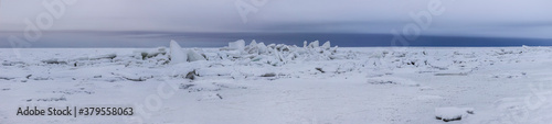 Panoramic landscape snow floes on the coastline of the Northern White sea.