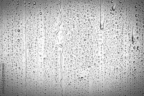 Drops water on the clear glass gray background. Water condensation