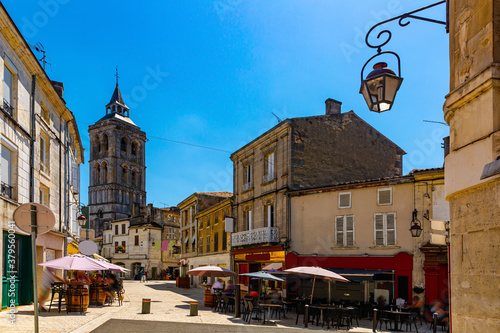 Fototapeta Naklejka Na Ścianę i Meble -  Central street of French town of Cognac overlooking bell tower of Saint Leger Church