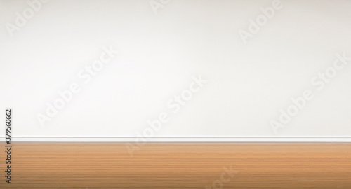 Empty wooden floor with white wall