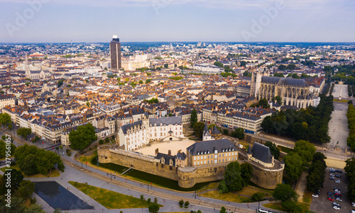 Aerial view of historic area of Nantes overlooking medieval Castle of Dukes of Brittany, Gothic Roman Catholic cathedral with Tour Bretagne on background, France © JackF