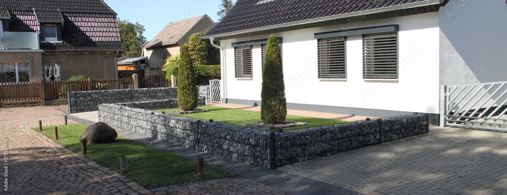 a new house with gabions as a fence