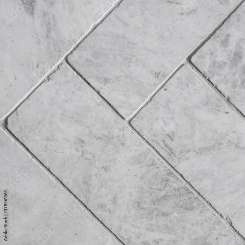 Gray floor tiles, herringbone pattern, close-up