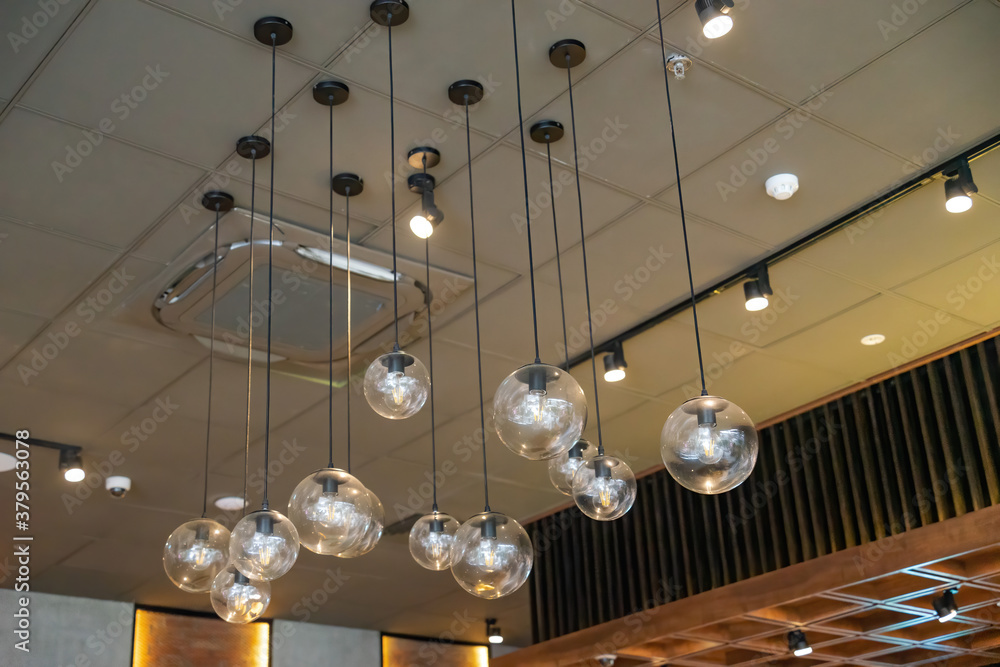 Selective focus of glass hanging lamps on white ceiling. vintage light bulbs. Selective focus of glass hanging lamps on white ceiling. vintage light bulbs.