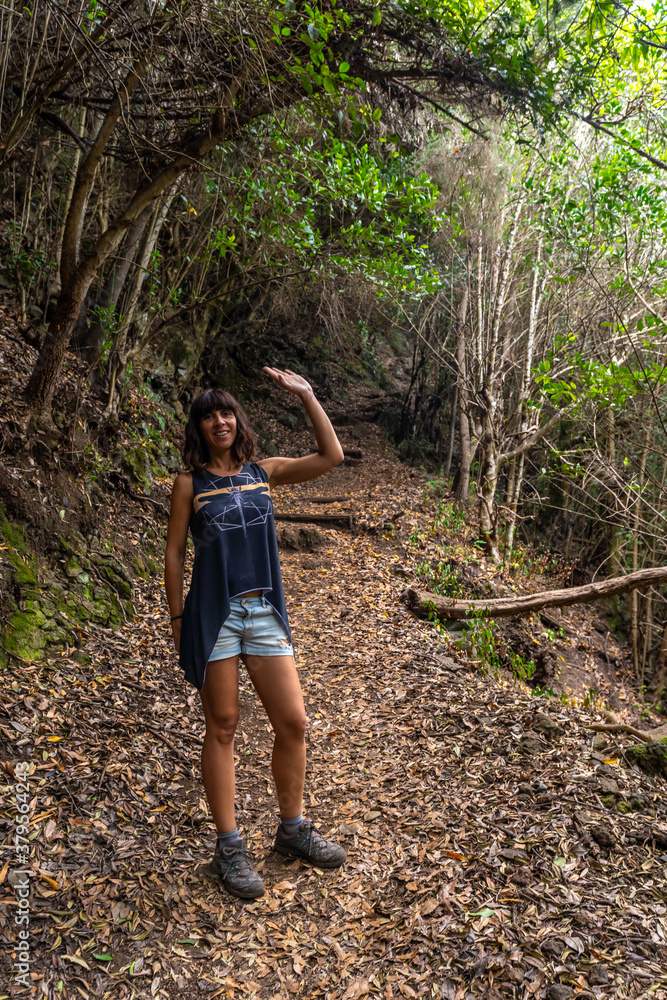 A young woman on the trekking trail of the Los Tinos natural park on the northeast coast on the island of La Palma, Canary Islands. Spain A young woman on the trekking trail of the Los Tinos natural park on the northeast coast on the island of La Palma, Canary Islands. Spain