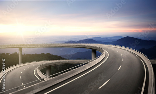 Highway overpass motion blur with nature mountain background during sunrise.