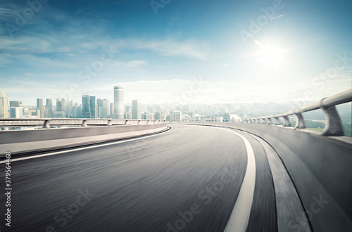 Obraz na plátně Highway overpass motion blur effect with modern city background