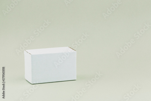 White small paper box on a light background. Background with place for text