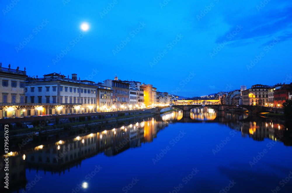 NIght view of townscape at the edges of the Arno river,  in Florence, Italy. Fiume Arno.