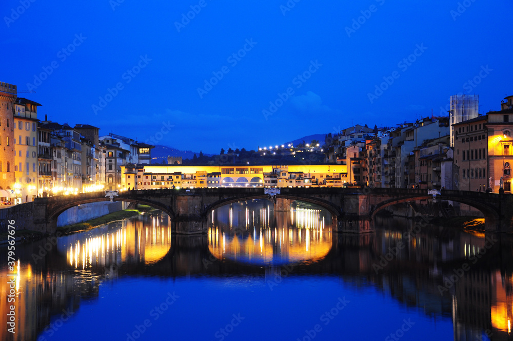 NIght view of townscape at the edges of the Arno river,  in Florence, Italy. Fiume Arno.