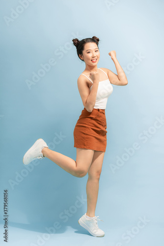 Fototapeta Naklejka Na Ścianę i Meble -  Full length size studio photo portrait of pretty sweet cute cheerful joyful lady standing on one leg isolated vivid background