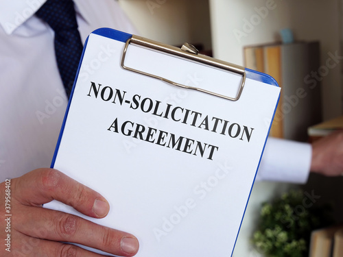 Non solicitation Agreement concept. The manager offers to sign the documents. photo