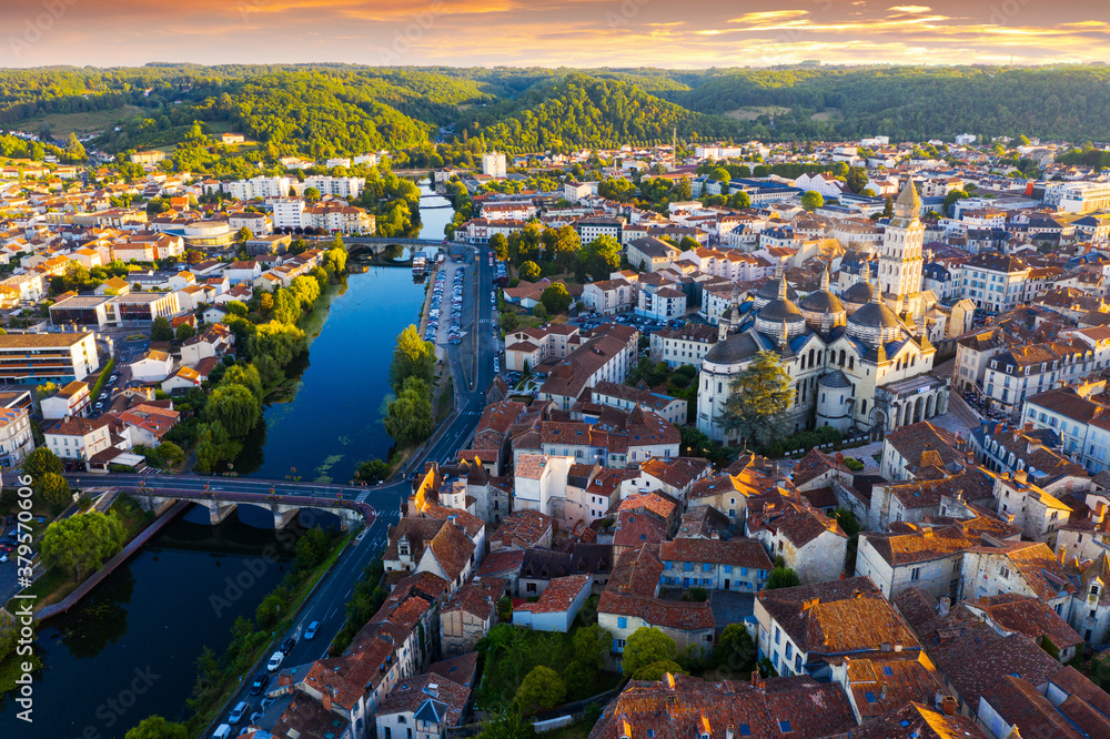 Obraz premium Drone view of French city of Perigueux on Isle River overlooking Romanesque building of ancient cathedral during summer sunset..