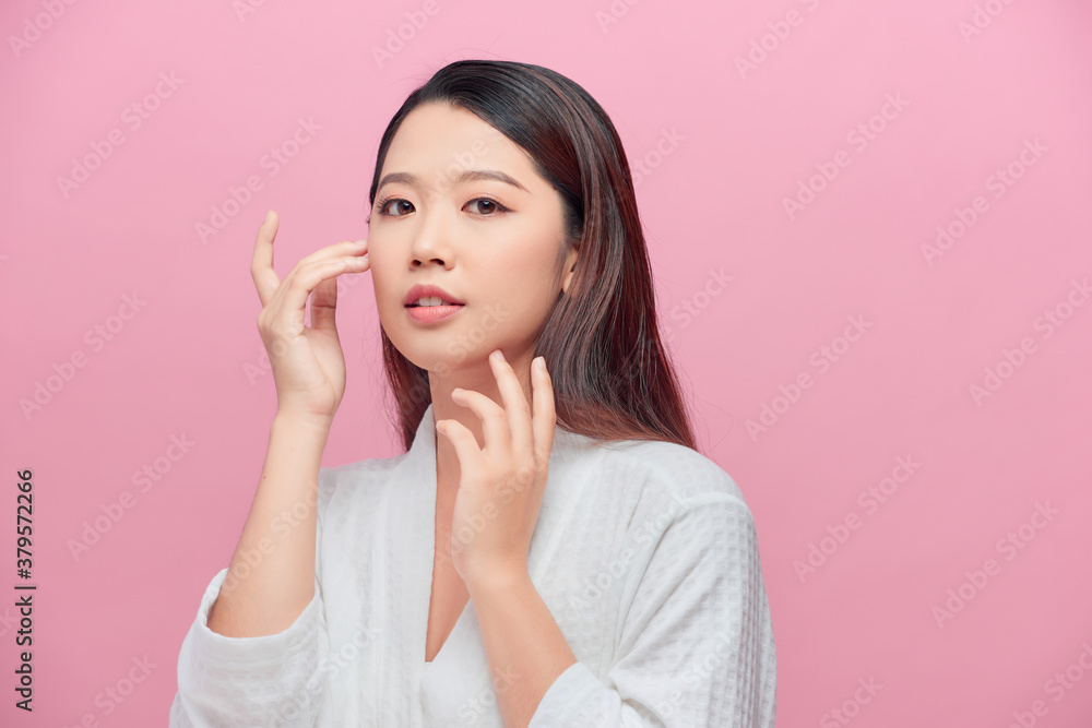 Portrait of beautiful woman with natural make up touching her face Portrait of beautiful woman with natural make up touching her face