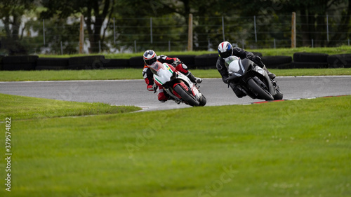 A shot of two racing bikes cornering as they circuit a track.