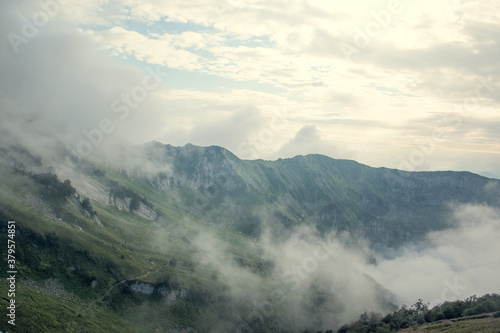 Landscape on mountains with clouds. Bird's eye view. Early, Sunny morning. Sochi. Krasnaya Polyana. A soft picture. © Антонина Кузнецова
