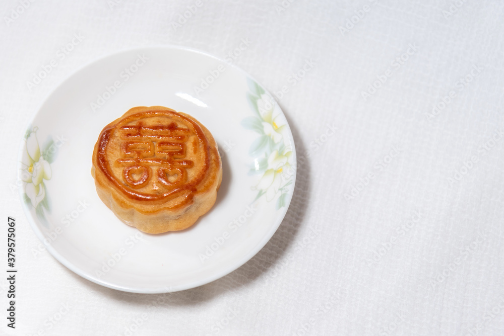 Chinese traditional food , pie with chinese character for happiness , betrothal gift , mooncake on plate Chinese traditional food , pie with chinese character for happiness , betrothal gift , mooncake on plate