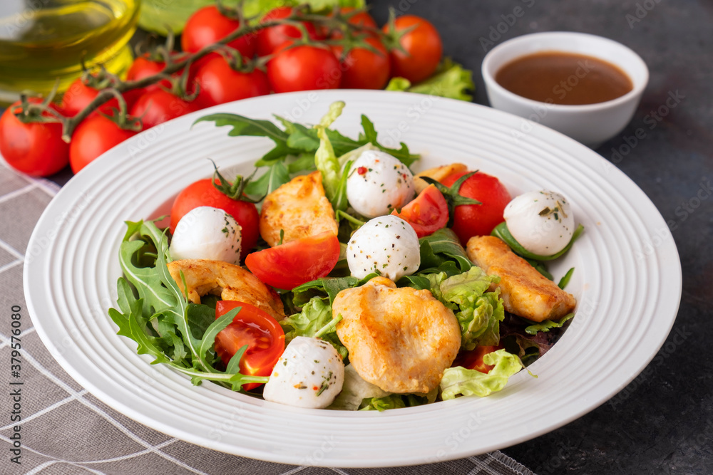 Tasty salad with chicken, mozzarella, arugula and cherry tomatoes. Healthy and diet salad Tasty salad with chicken, mozzarella, arugula and cherry tomatoes. Healthy and diet salad
