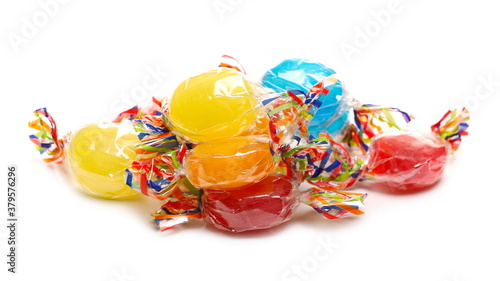 Billede på lærred Colorful candies with transparent cellophane wrapping, sweets pile isolated on w