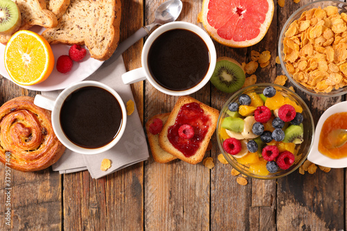 cornflake, fresh fruit, bread and coffee cup