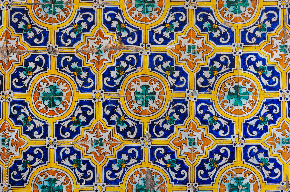 Ceramic tiles (azulejos) with floral patterns on a wall of the Alcazar of Seville, Spain