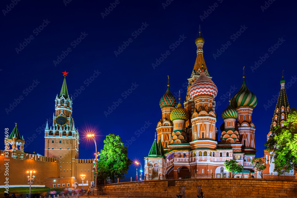 Saint Basil Cathedral on Red Square at night with Kremlin wall and Tower i Moscow, Russia