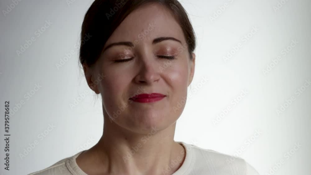 A young woman puts medical mask on her face on white background. A young woman puts medical mask on her face on white background.